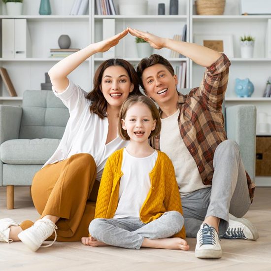 Mother, father and child girl in the room with a symbol of roof. Concept of housing for young family.